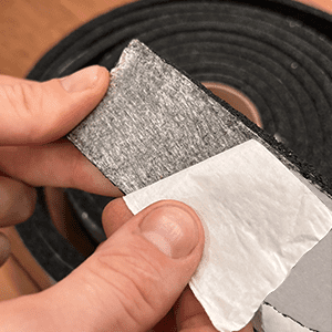 Peeling self adhesive off a rubber roll