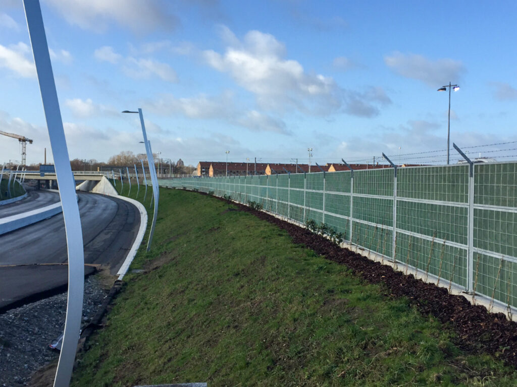 installing an acoustic barrier beside a road