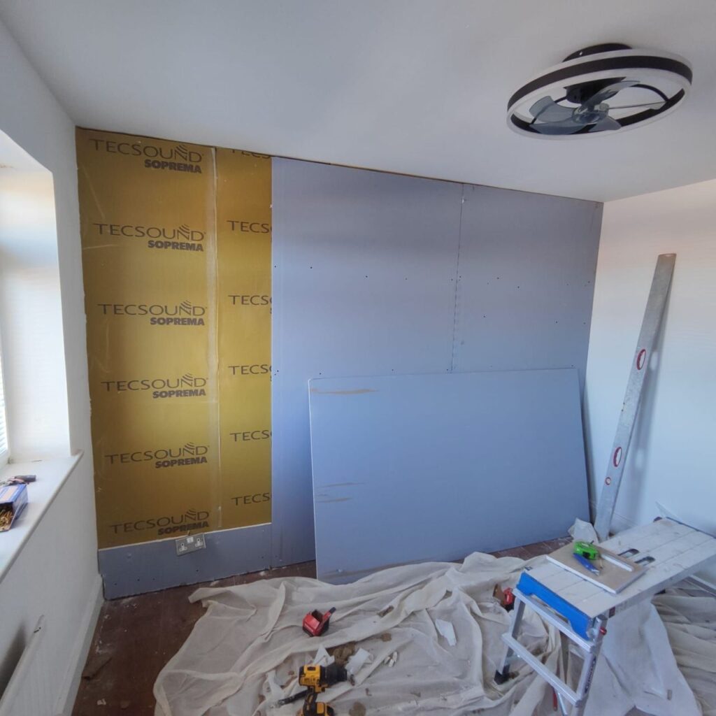 Tecsound soundprrofing membrane and acoustic plasterboard applied to wall