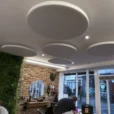 Circle acoustic panels on the ceiling in a barber shop