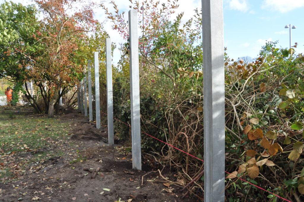 steel posts dug into the ground ready for acoustic fence panels to be attached.