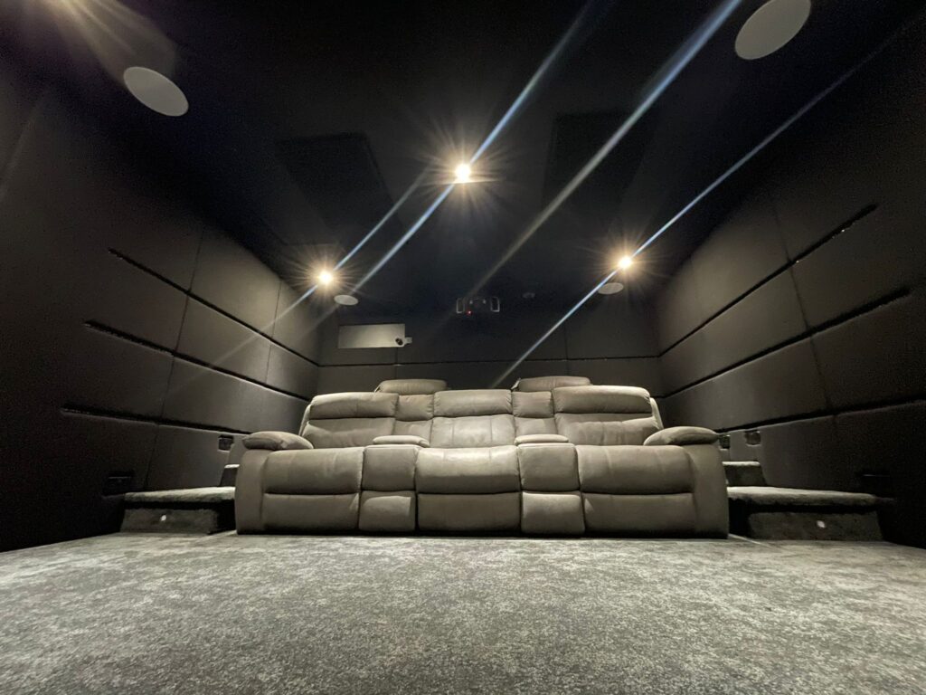 low angle of home cinema with sofas and acoustic wall panels