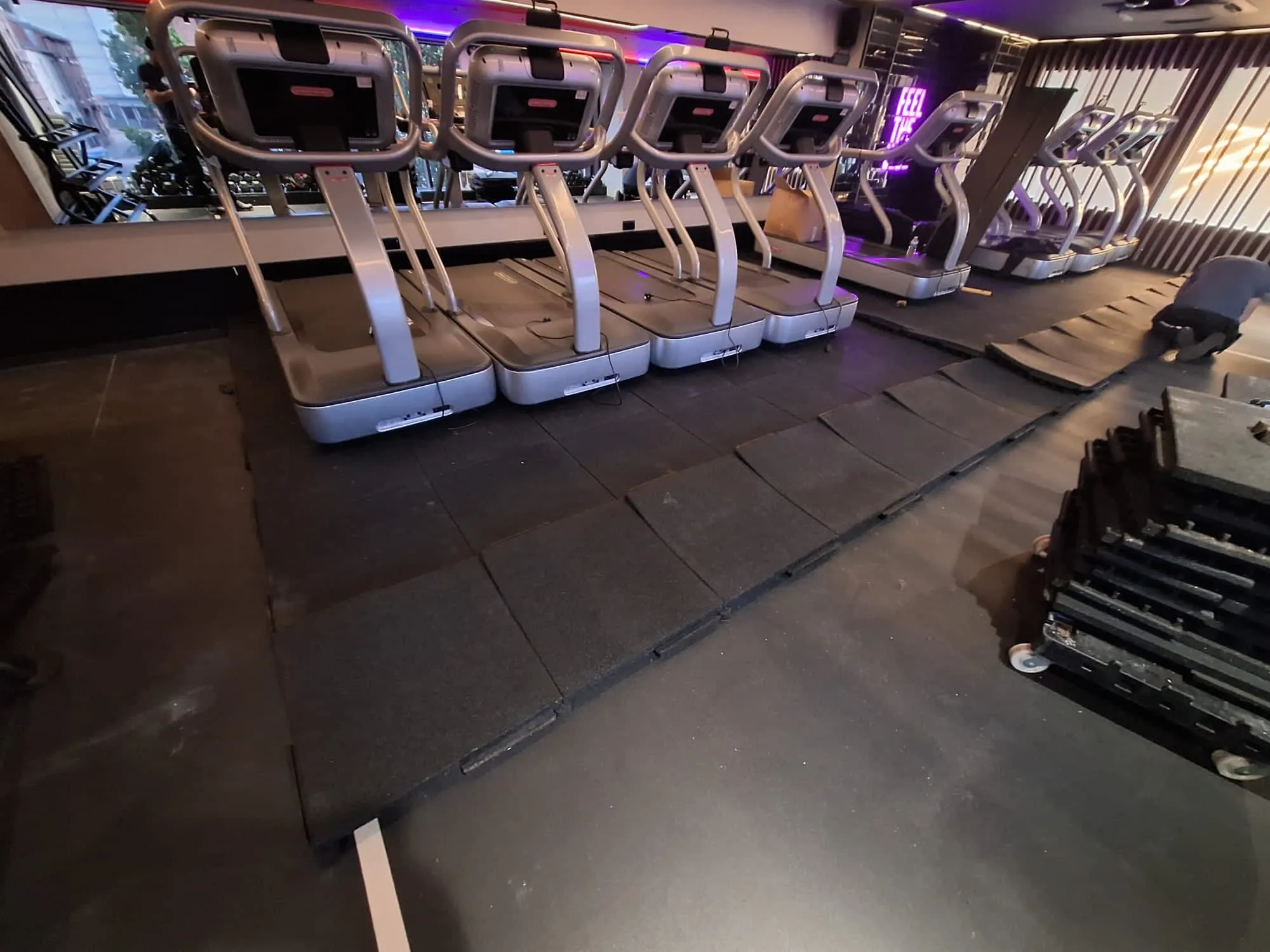 soundproof flooring being installed in a gym