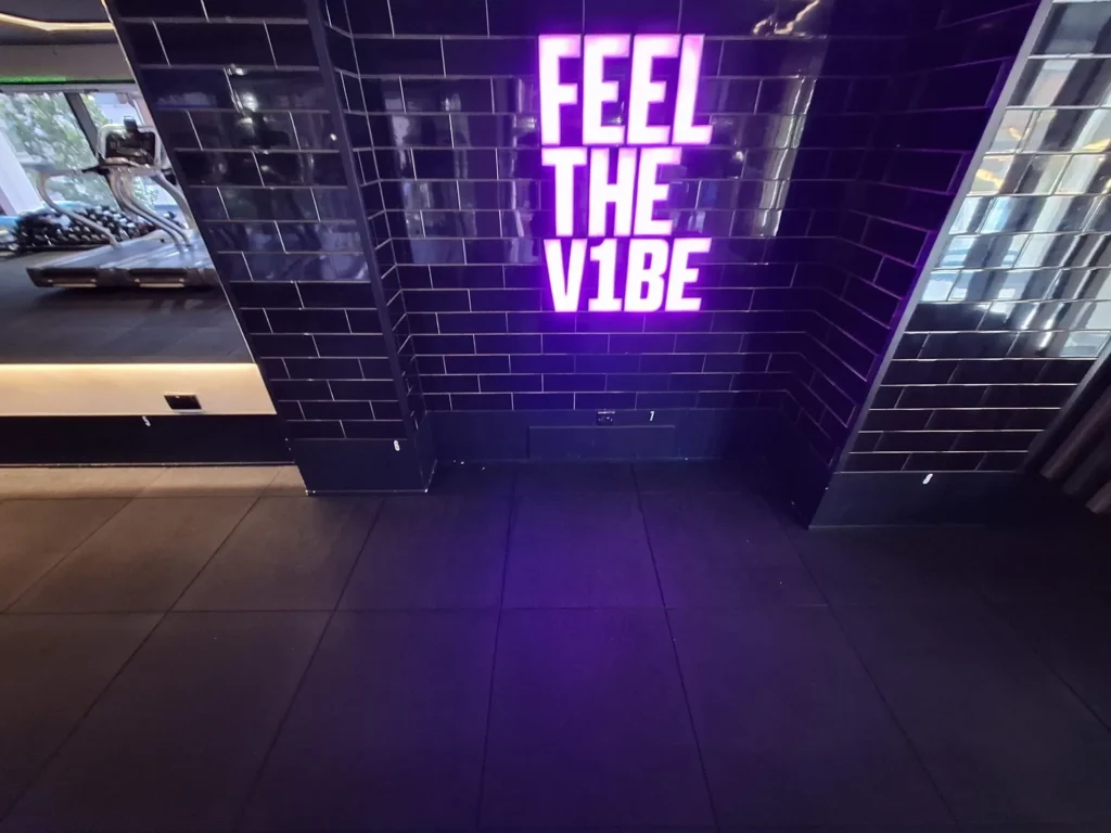 Neon sign in a gym with soundproof flooring